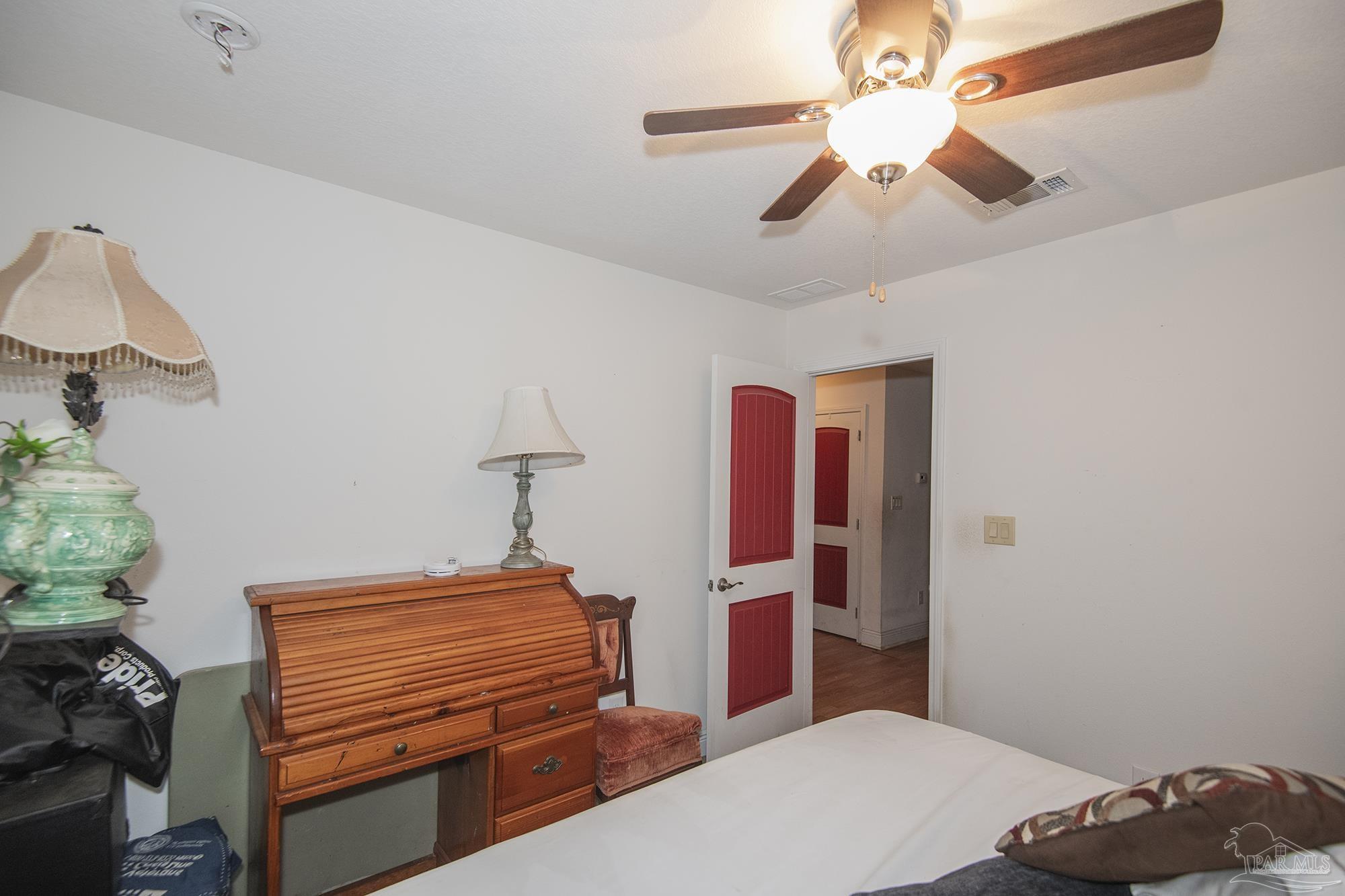 5800 Providence Loop Pensacola, FL 32526 - Photo 16 of 29 a bedroom with a bed and a chandelier