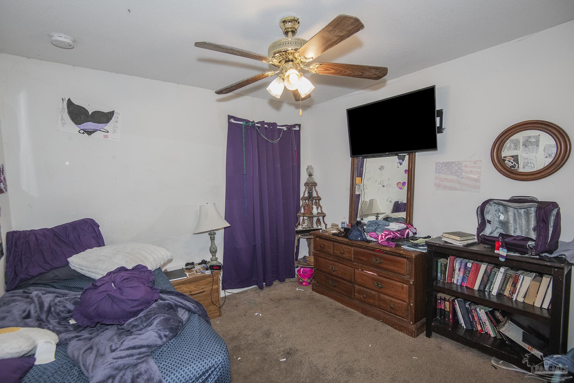 5800 Providence Loop Pensacola, FL 32526 - Photo 17 of 29 a living room with furniture a flat screen tv and a book shelf