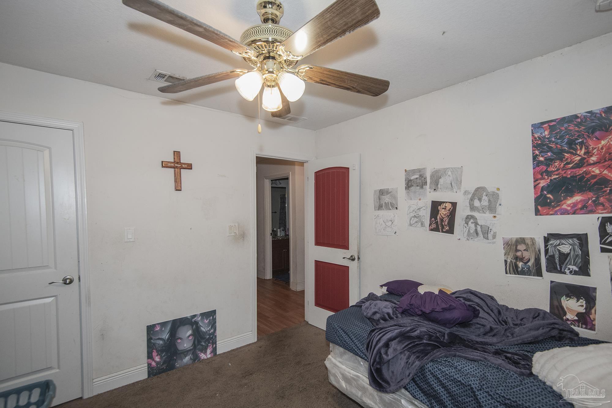 5800 Providence Loop Pensacola, FL 32526 - Photo 19 of 29 a bedroom with a bed and a chandelier