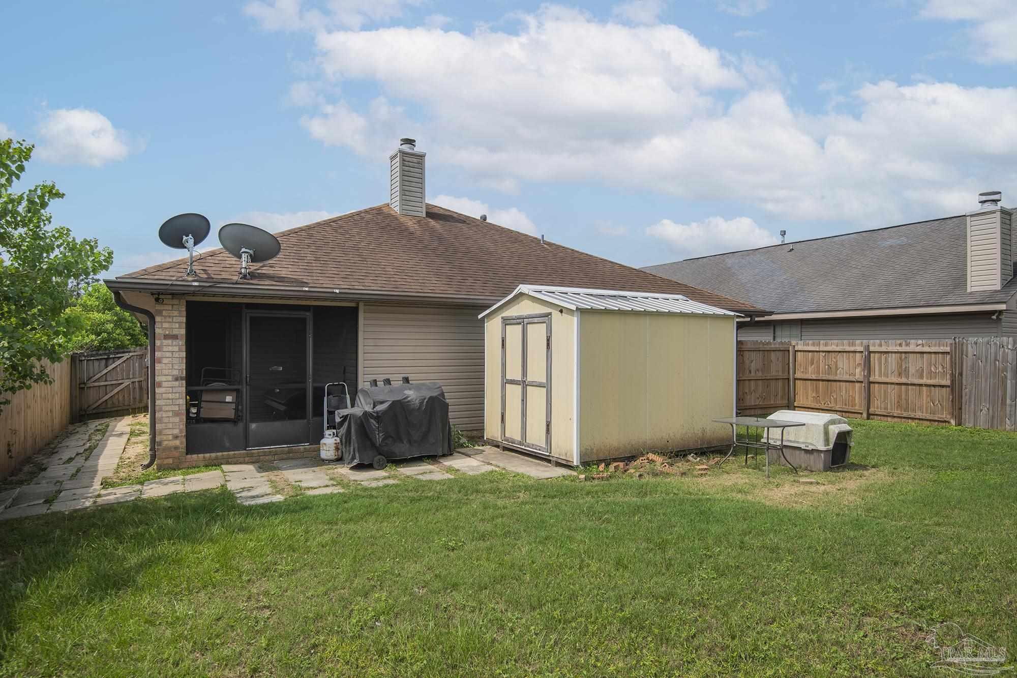 5800 Providence Loop Pensacola, FL 32526 - Photo 26 of 29 a front view of a house with a garden and plants