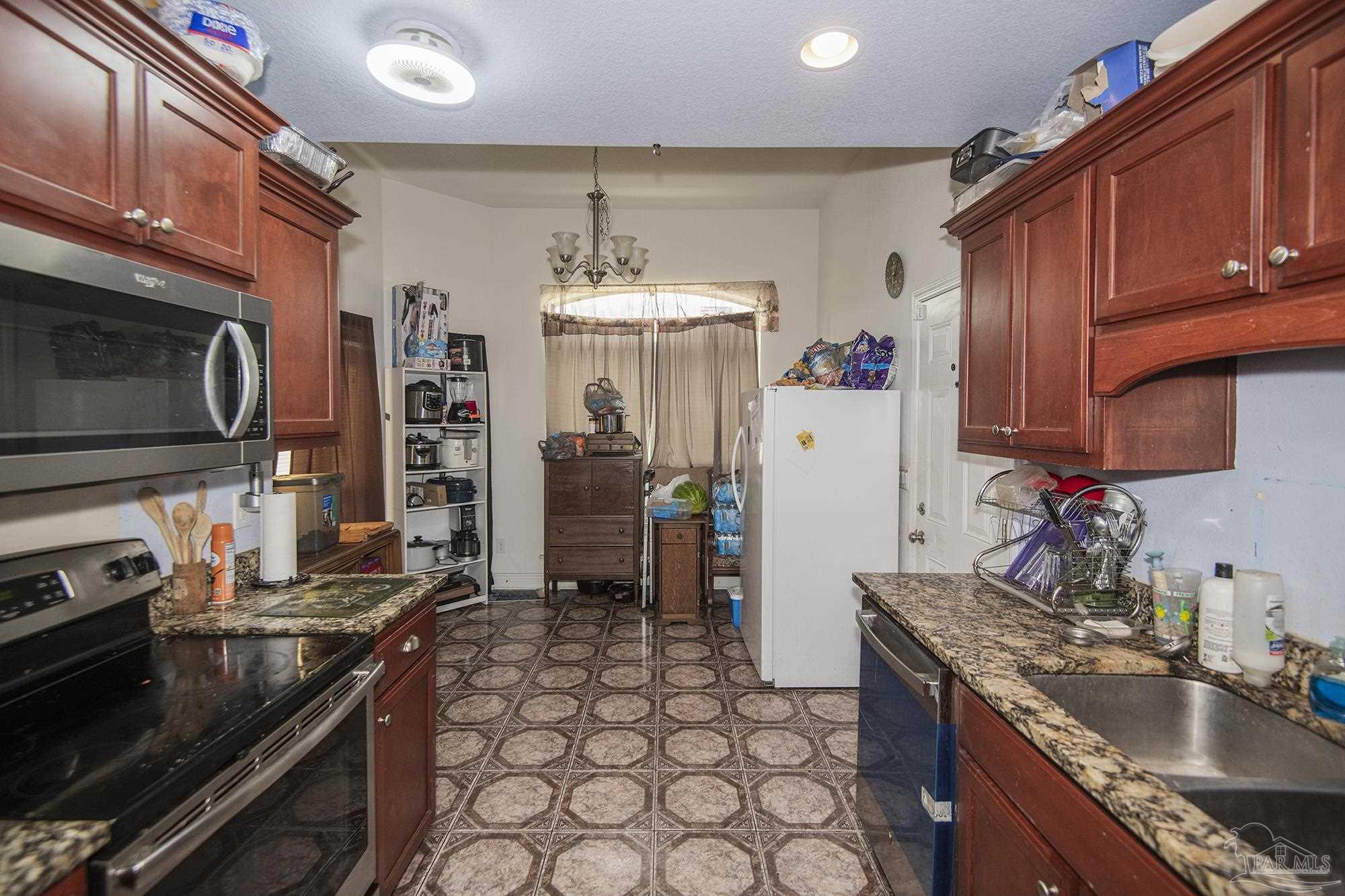 5800 Providence Loop Pensacola, FL 32526 - Photo 6 of 29 a kitchen with a sink stove and refrigerator