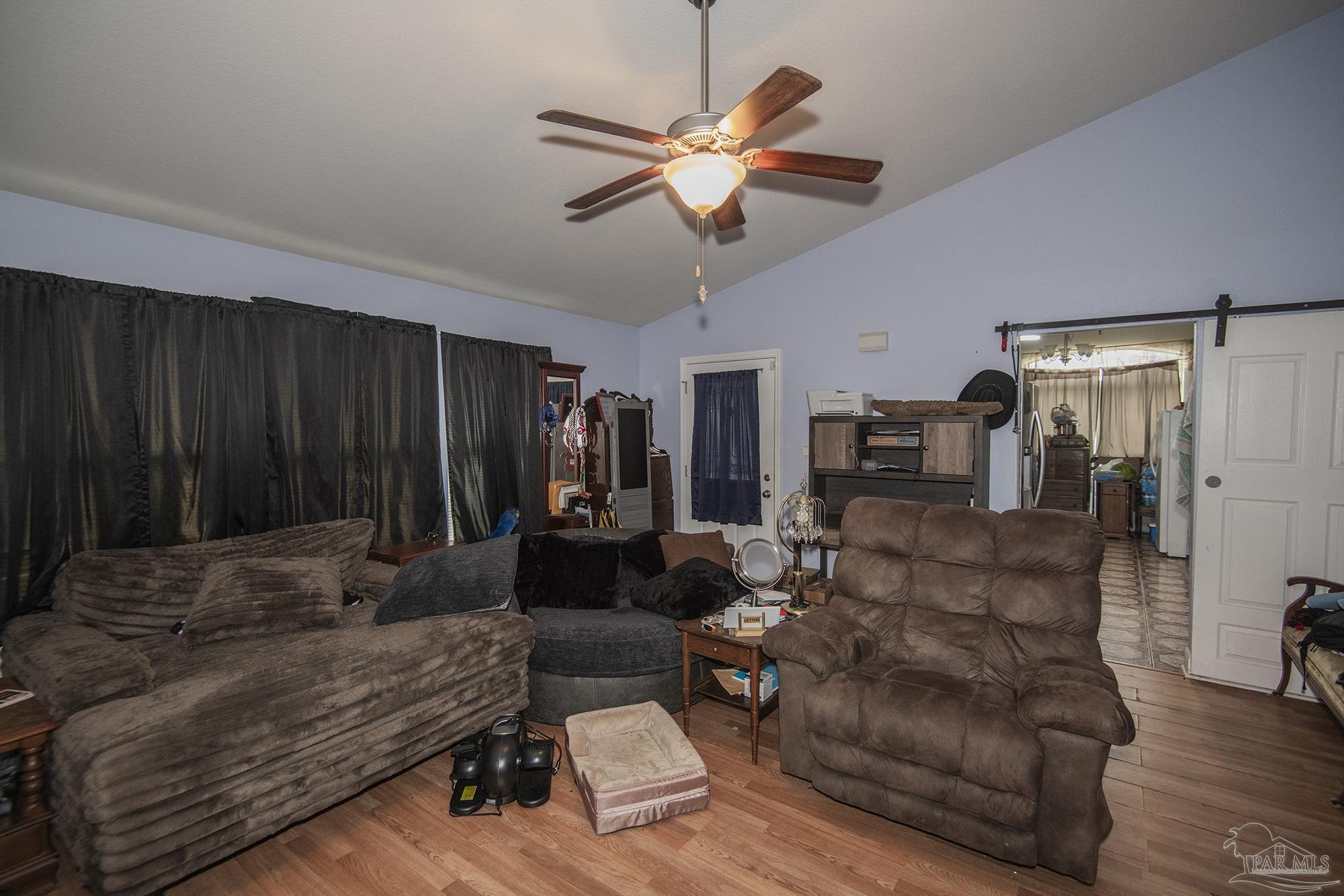 5800 Providence Loop Pensacola, FL 32526 - Photo 9 of 29 a living room with furniture ceiling fan and a wooden floor