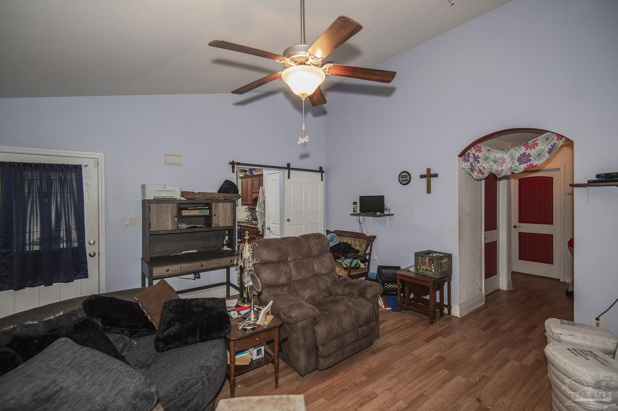 5800 Providence Loop Pensacola, FL 32526 - Photo 10 of 29 a living room with furniture a fireplace and a chandelier