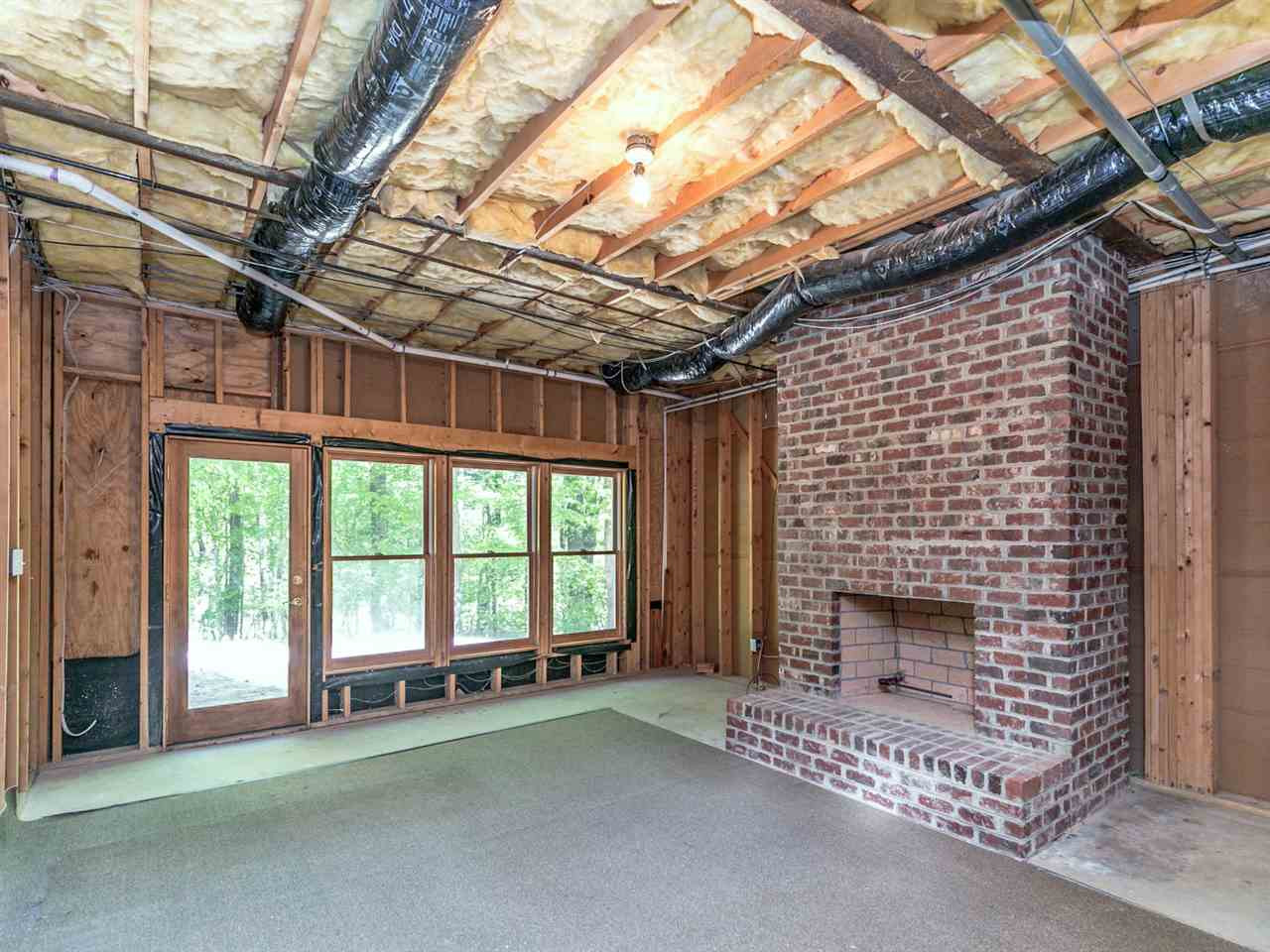 1609 Adams Mountain Road Raleigh, NC 27614 - Photo 20 of 29 The large walkout basement has a gas fireplace, high end wood windows, and 11 foot ceilings. This room leads to a large workshop, an additional room for storage, and the lower level two car garage with full bay extension. Basement