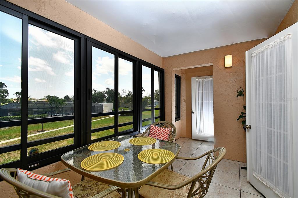 601 Islamorada Boulevard, Unit 24B Punta Gorda, FL 33955 - Photo 17 of 36 a dining room with furniture and a floor to ceiling window
