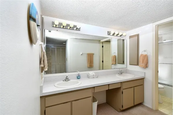 a bathroom with a double vanity sink mirror and