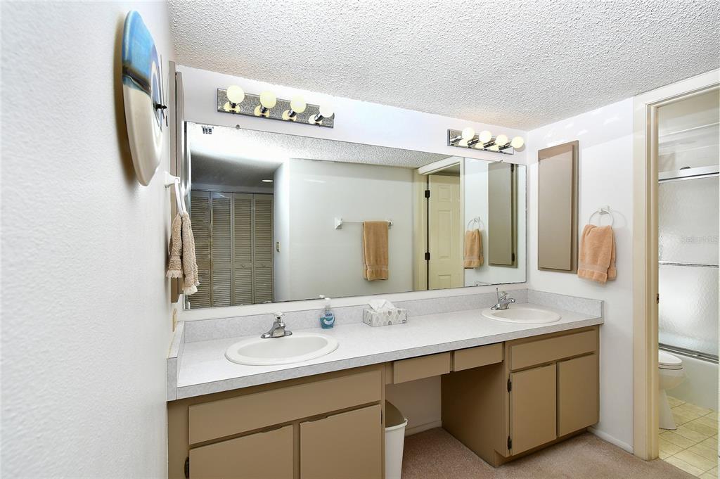 601 Islamorada Boulevard, Unit 24B Punta Gorda, FL 33955 - Photo 22 of 36 a bathroom with a double vanity sink mirror and