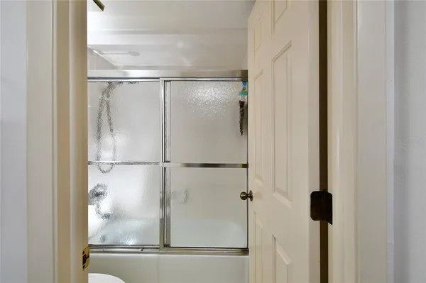 a bathroom with a glass shower door