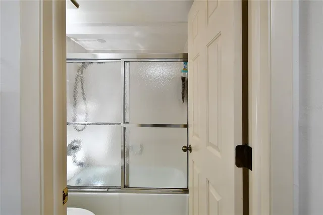 a bathroom with a glass shower door