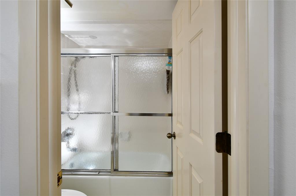 601 Islamorada Boulevard, Unit 24B Punta Gorda, FL 33955 - Photo 23 of 36 a bathroom with a glass shower door