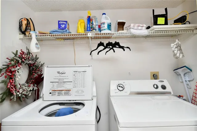 a utility room with sink washer and dryer