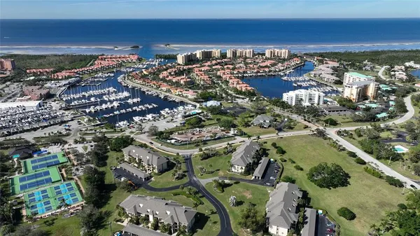 an aerial view of residential houses with outdoor space and trees