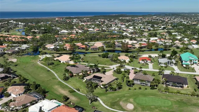 an aerial view of a house with a garden and houses