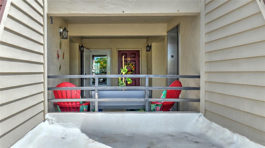 601 Islamorada Boulevard, Unit 24B Punta Gorda, FL 33955 - Photo 4 of 36 a living room with furniture and a book shelf