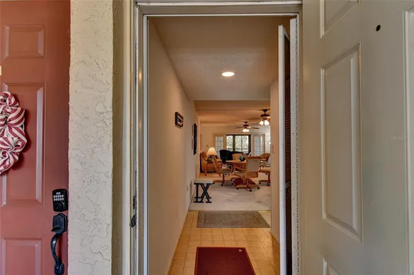 a view of a hallway with living room and dining room view