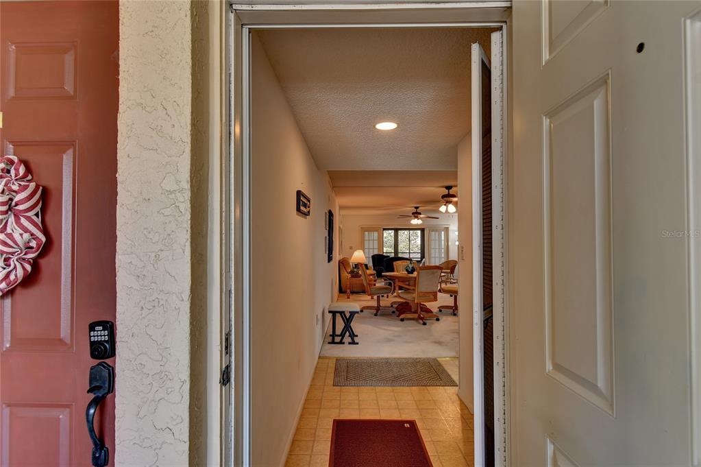 601 Islamorada Boulevard, Unit 24B Punta Gorda, FL 33955 - Photo 6 of 36 a view of a hallway with living room and dining room view