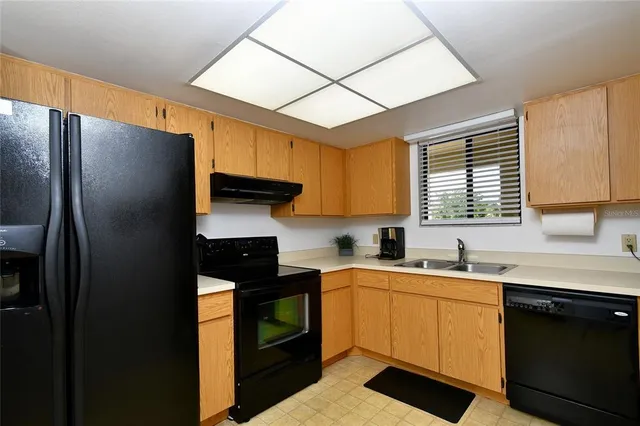 a kitchen with a sink appliances and cabinets