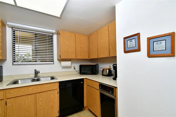 a kitchen with a sink cabinets and window