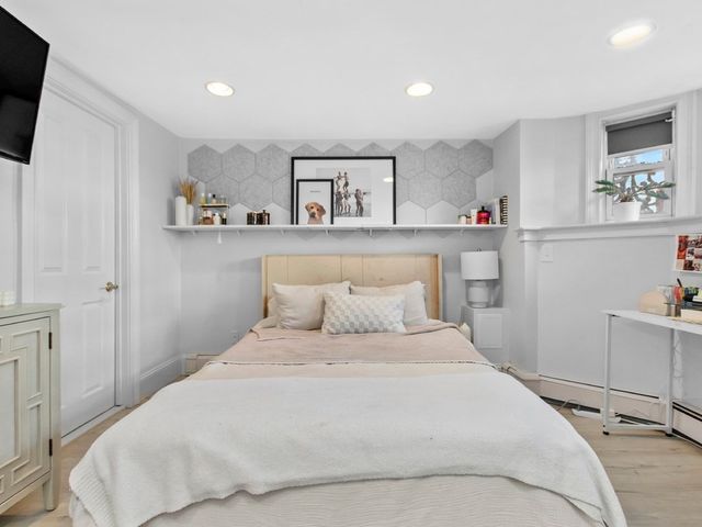 a bedroom with a bed and a window