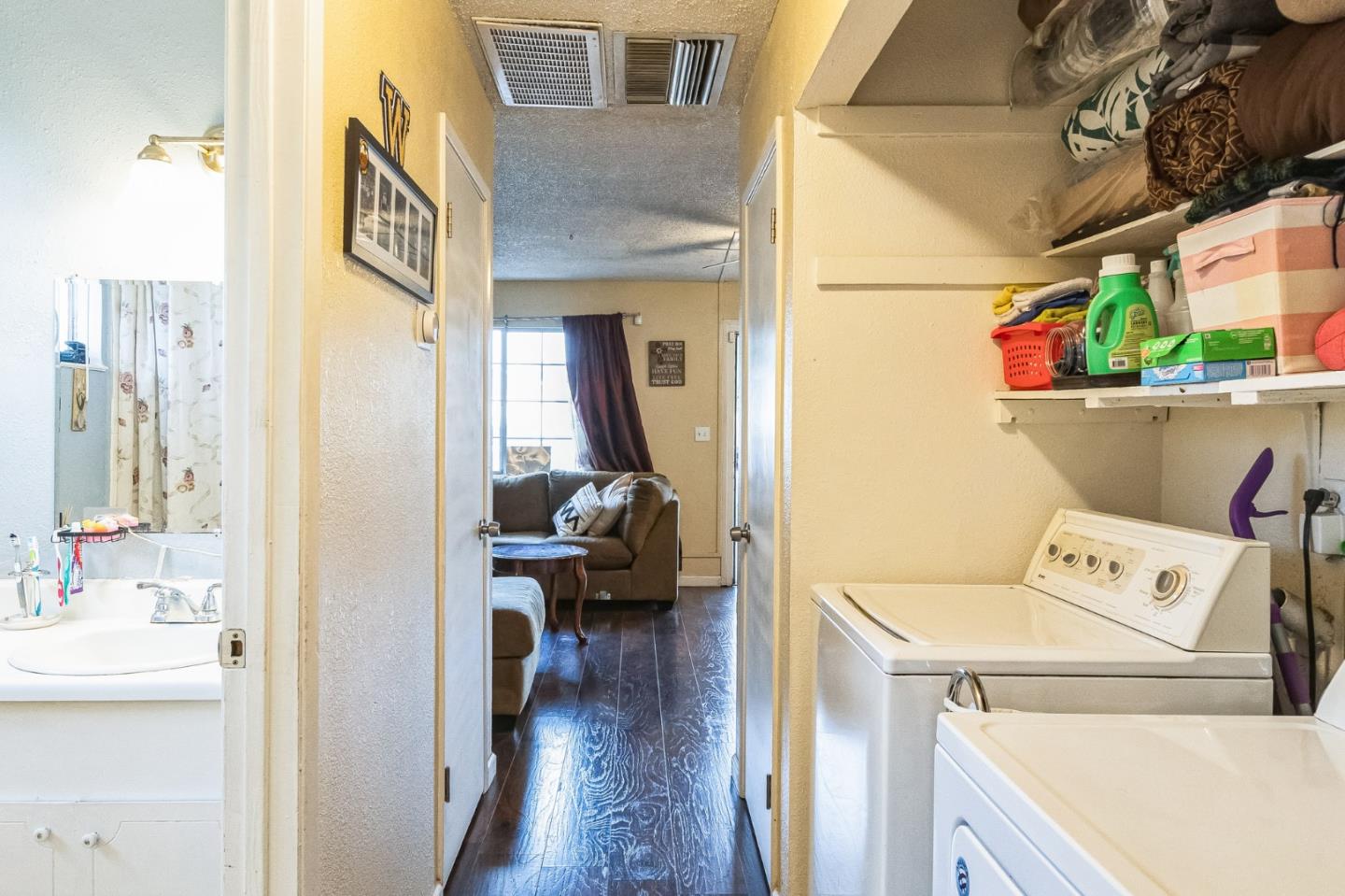 708 Sequoia Boulevard Tracy, CA 95376 - Photo 6 of 14 a utility room with dryer washer and a view of living area