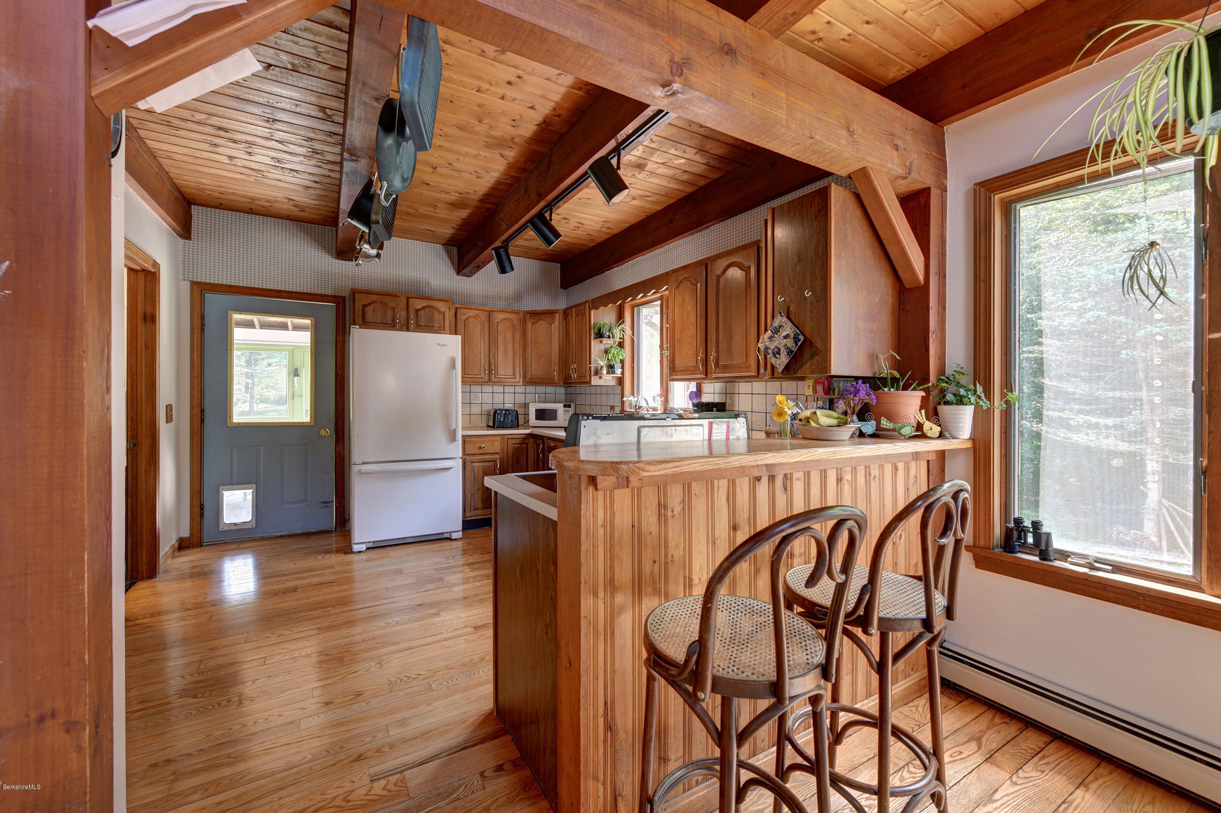 26 Andes Road Peru, MA 01235 - Photo 11 of 52 a dining room with furniture a kitchen view and wooden floor