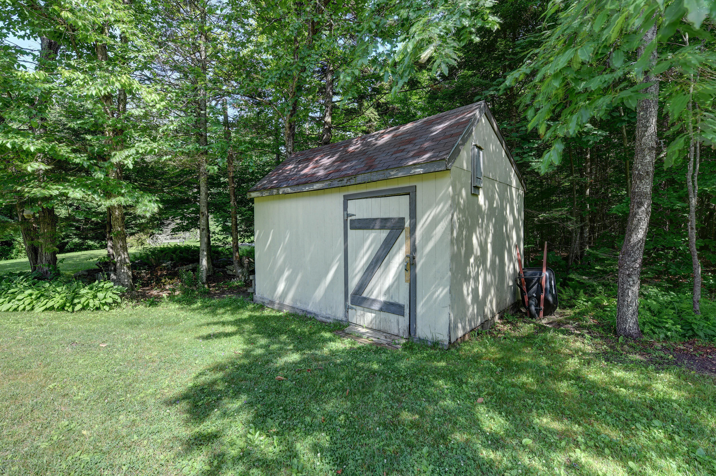 26 Andes Road Peru, MA 01235 - Photo 43 of 52 a view of a wooden house with a small yard and large trees