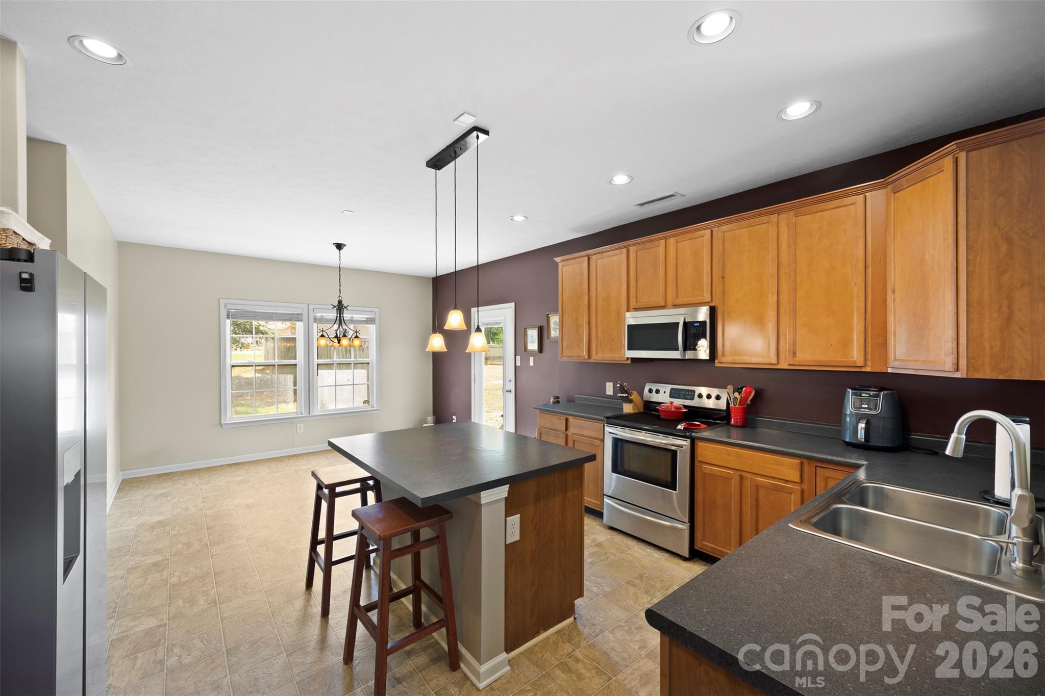 1720 Grove Tree Lane Clover, SC 29710 - Photo 11 of 43 a kitchen with stainless steel appliances granite countertop a sink a stove counter space and a window