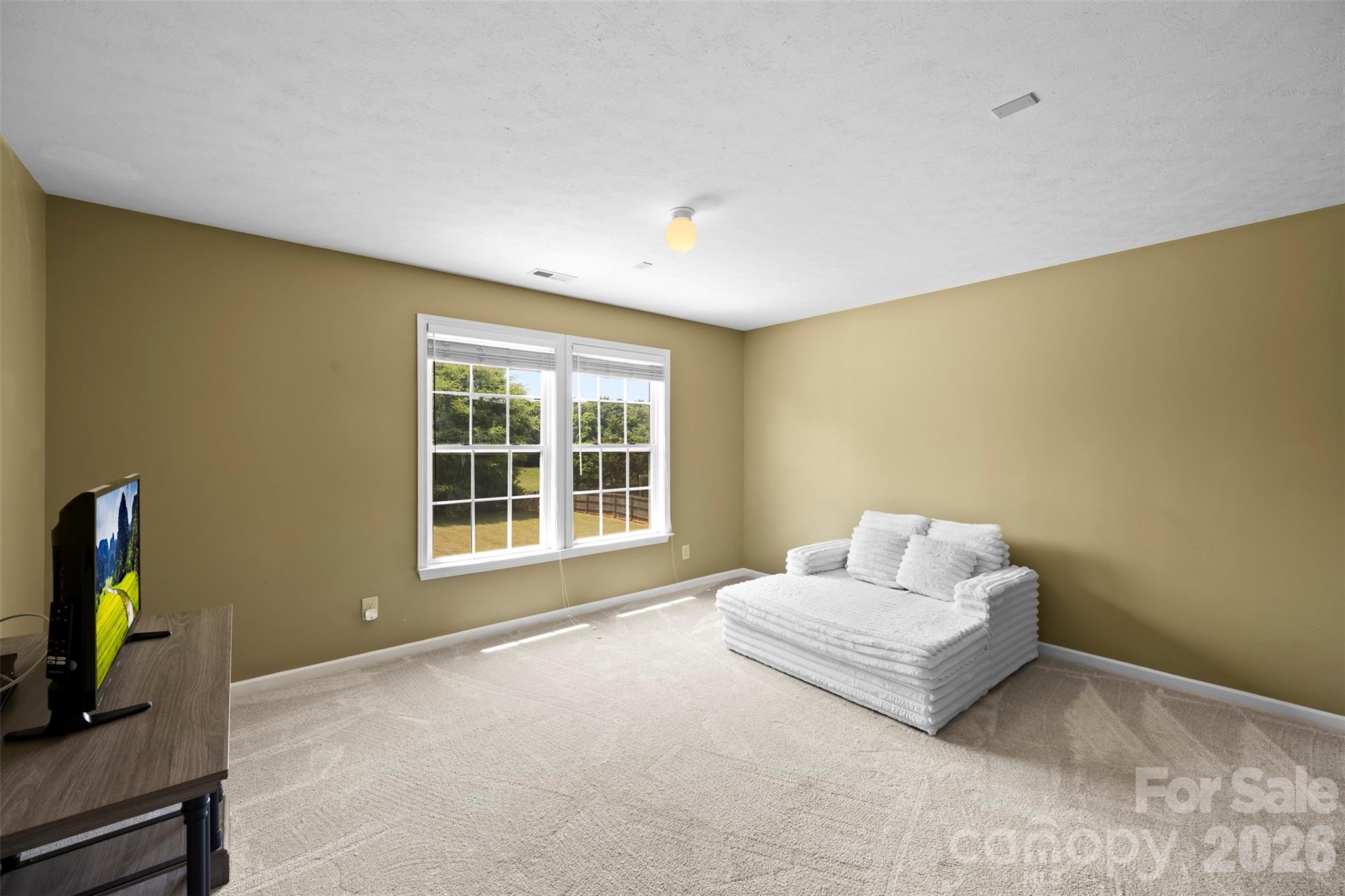 1720 Grove Tree Lane Clover, SC 29710 - Photo 20 of 43 a spacious bedroom with a bed and a flat screen tv