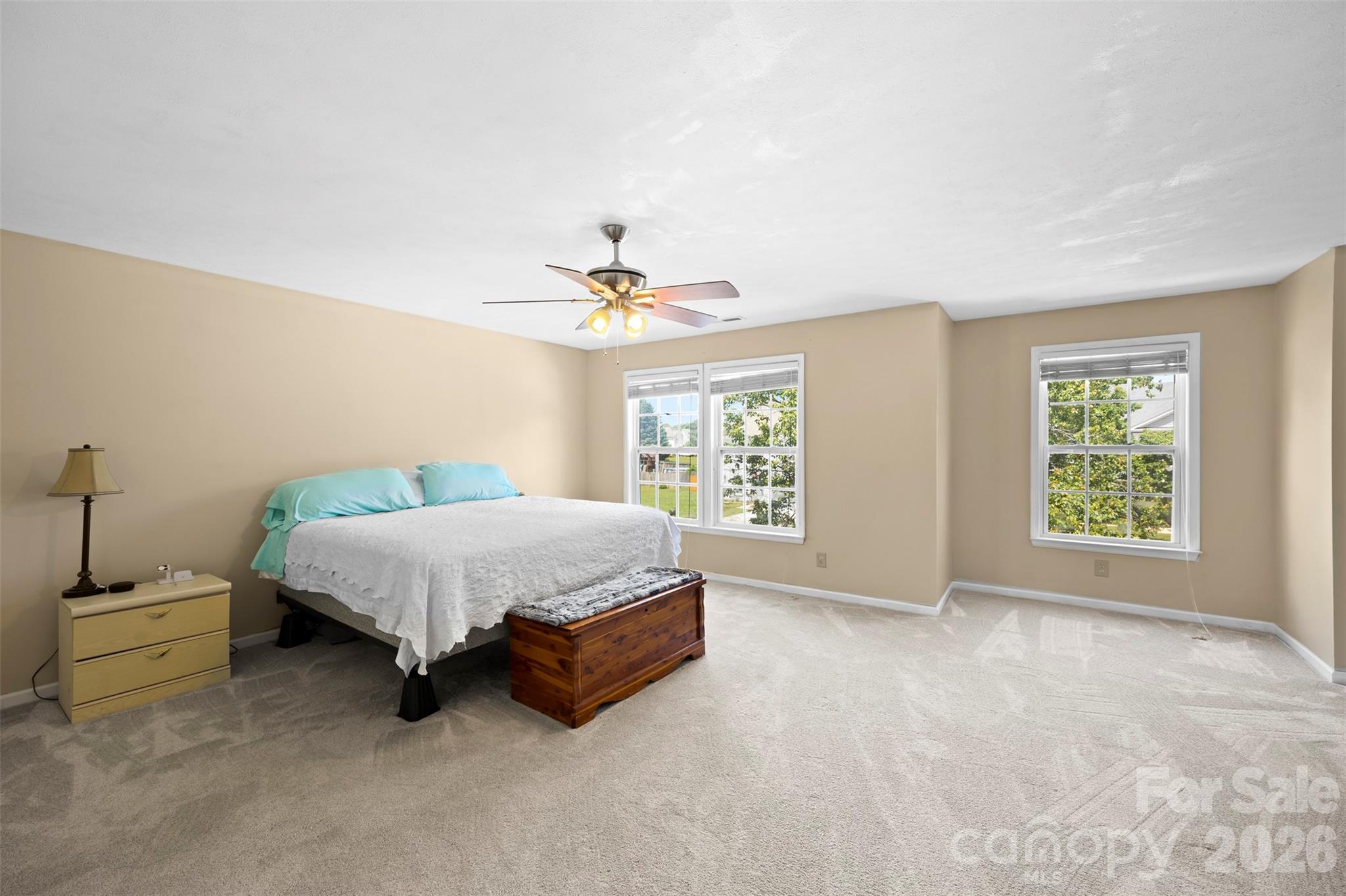 1720 Grove Tree Lane Clover, SC 29710 - Photo 30 of 43 a spacious bedroom with a bed and a chandelier