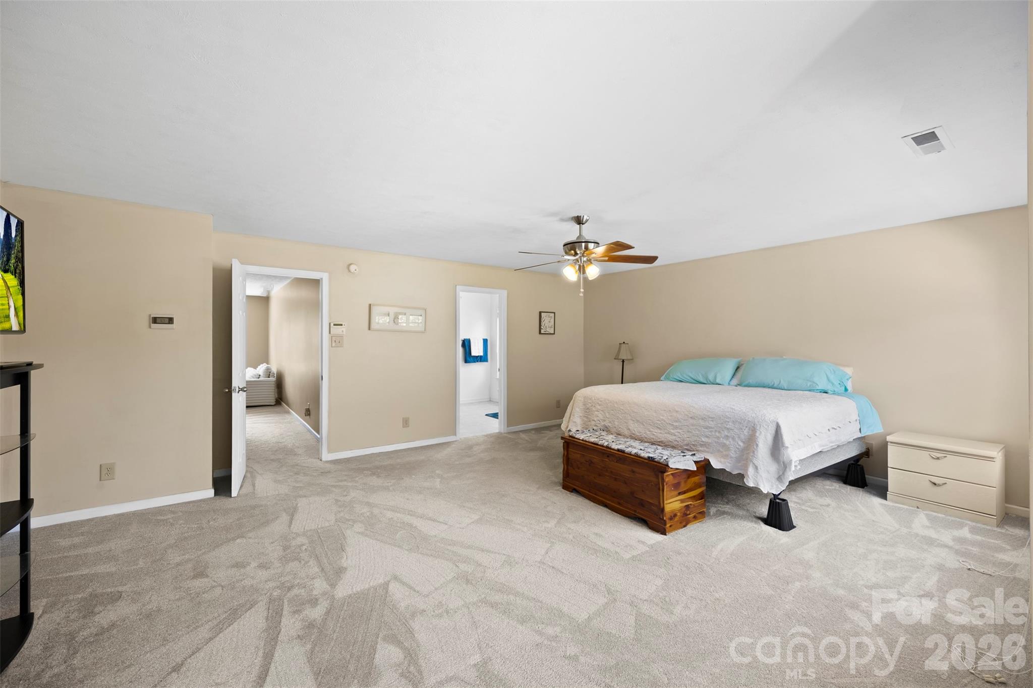 1720 Grove Tree Lane Clover, SC 29710 - Photo 31 of 43 a spacious bedroom with a bed and a chandelier