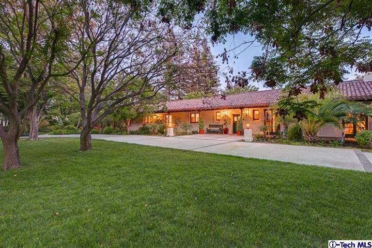a view of backyard of house with green space