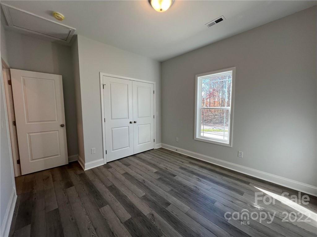 508 Willow Road Salisbury, NC 28147 - Photo 11 of 17 an empty room with wooden floor and windows