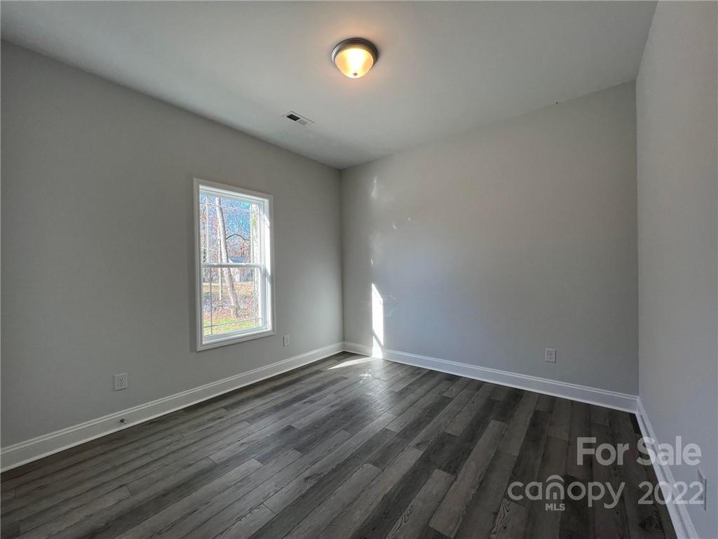 508 Willow Road Salisbury, NC 28147 - Photo 12 of 17 an empty room with wooden floor and windows