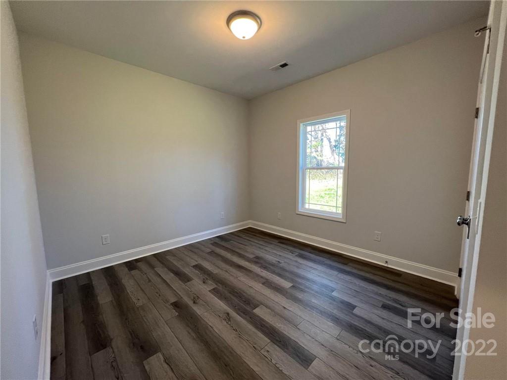 508 Willow Road Salisbury, NC 28147 - Photo 13 of 17 an empty room with wooden floor and windows