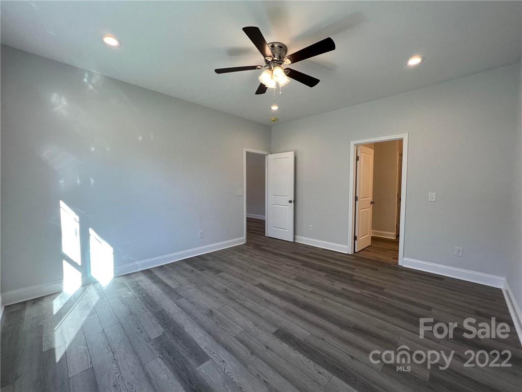 508 Willow Road Salisbury, NC 28147 - Photo 4 of 17 a view of an empty room with wooden floor and a ceiling fan