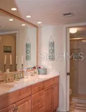 a bathroom with double vanity sink and a mirror