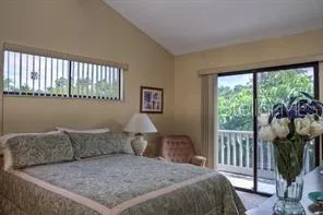 a bed sitting in a bedroom next to a window