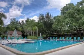 a view of a house with swimming pool and garden