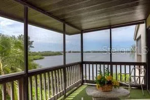 a view of a porch with a floor to ceiling window and wooden floor