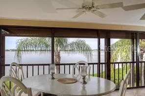 a dining room with wooden floor a glass table and chairs