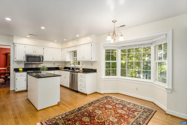a kitchen with a stove a sink and a refrigerator