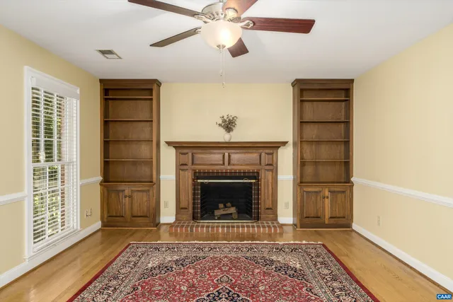 a living room with a fireplace and a rug