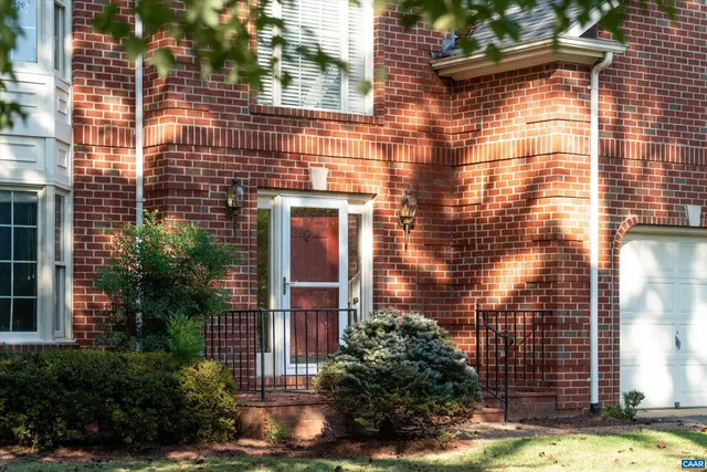 a view of a brick building next to a yard