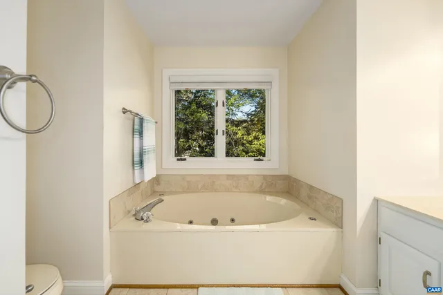 a white bath tub sitting next to a window