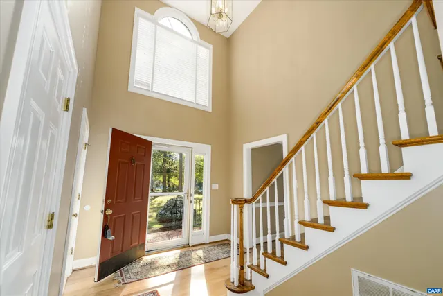 a view of entryway with wooden floor and stairs