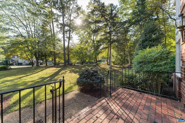a view of a swimming pool with a patio and backyard