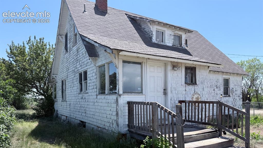 3380 Curtis Road Peyton, CO 80831 - Photo 13 of 13 White shingle-sided home with an asphalt shingle roof