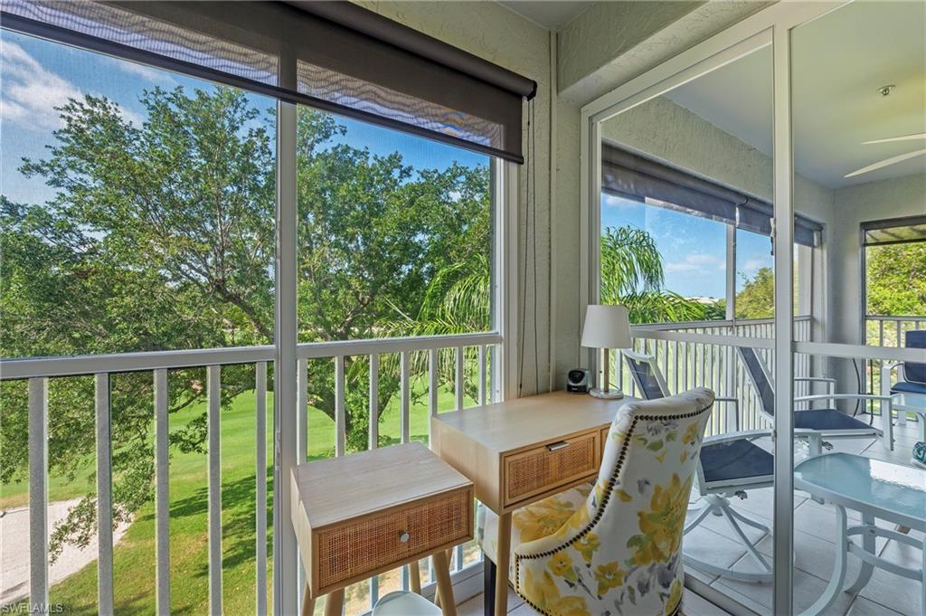 9300 Highland Woods Boulevard, Unit 3307 Bonita Springs, FL 34135 - Photo 18 of 43 a view of a balcony with chair and wooden floor