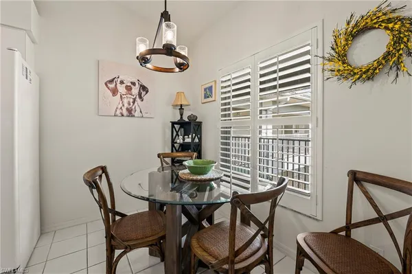 a view of a dining room with furniture and chandelier