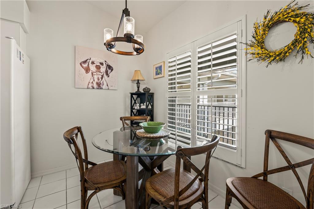 9300 Highland Woods Boulevard, Unit 3307 Bonita Springs, FL 34135 - Photo 2 of 43 a view of a dining room with furniture and chandelier